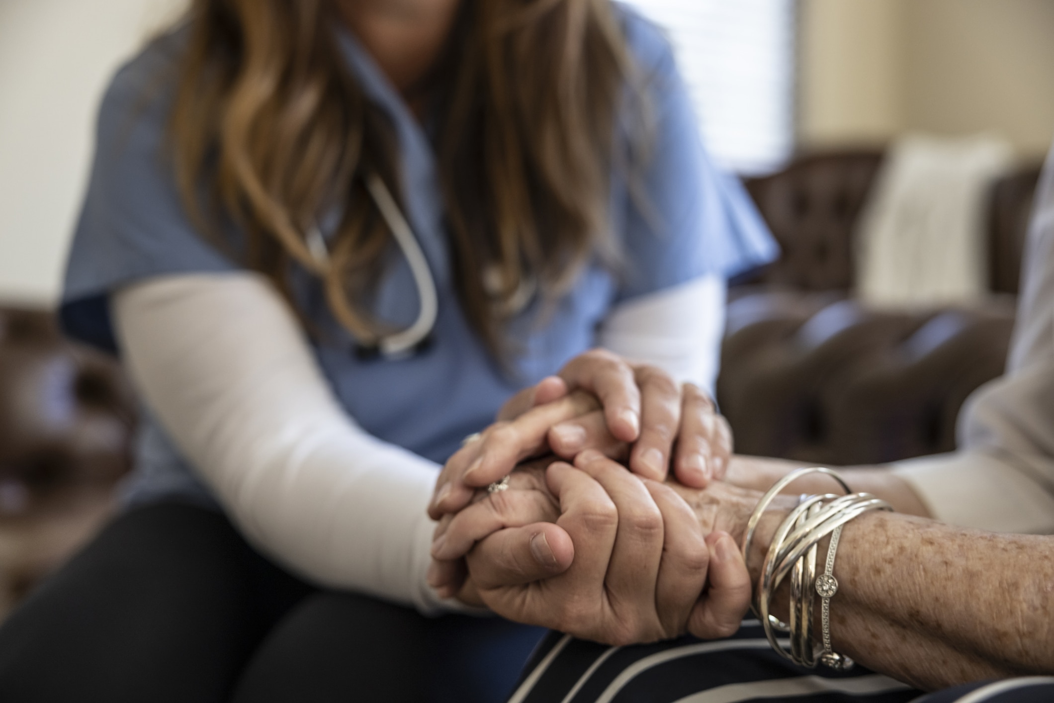 doctor holding patient's hand